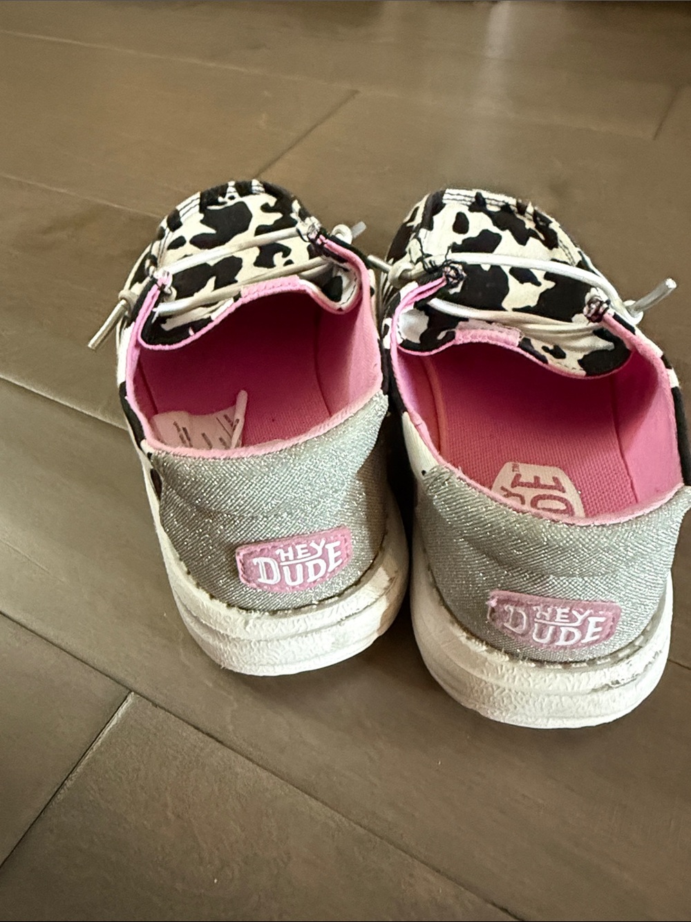 Hey Dude Kids Cow Print Slip-On Sneakers in Black, White & Pink - Picture 2 of 3